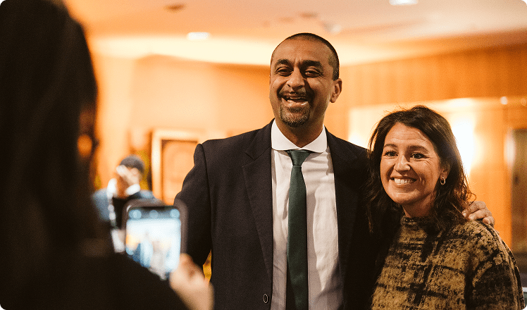 Ravi Kahlon speaking with a person at a conference. 