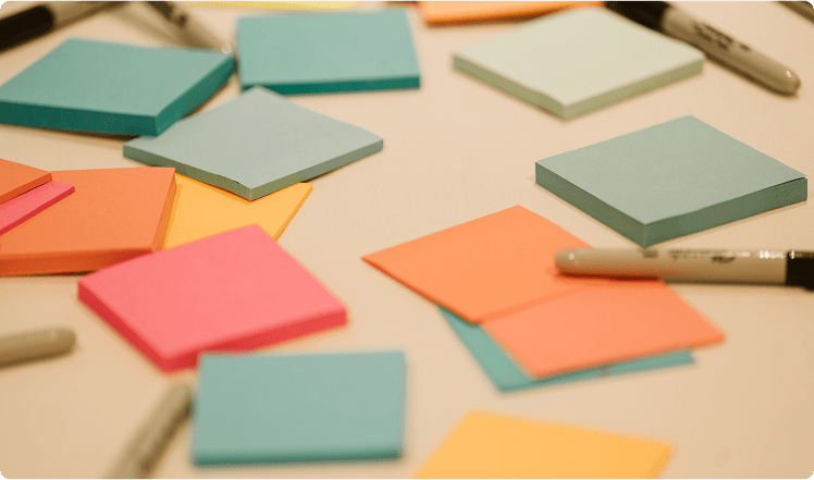 Several post it notes spread out on a table at a RENT event. 