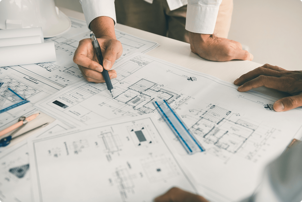 A group of engineers reviewing blueprints.