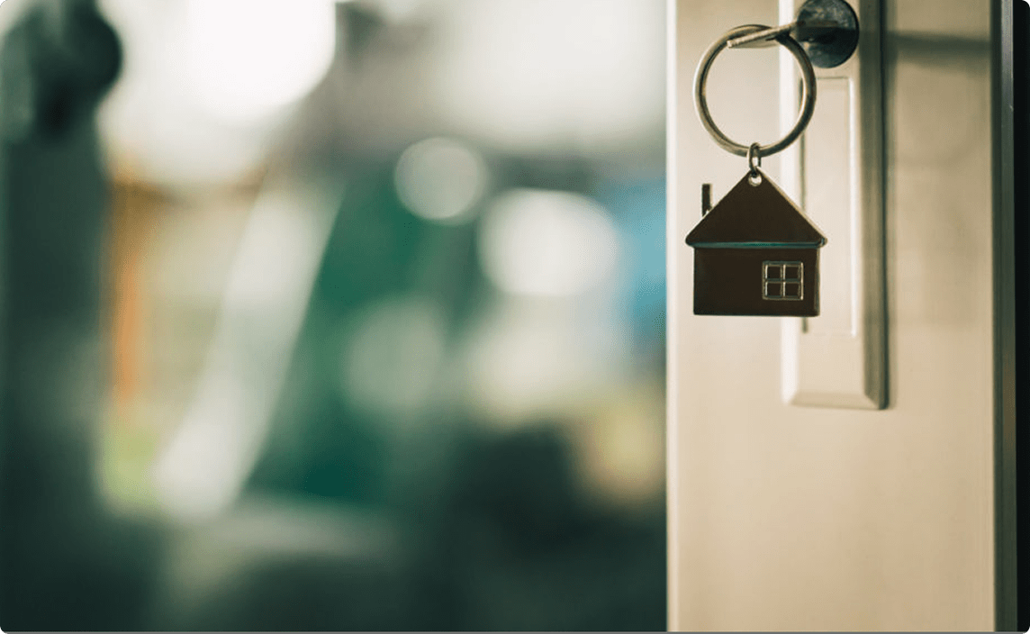 An image of a key in the door.