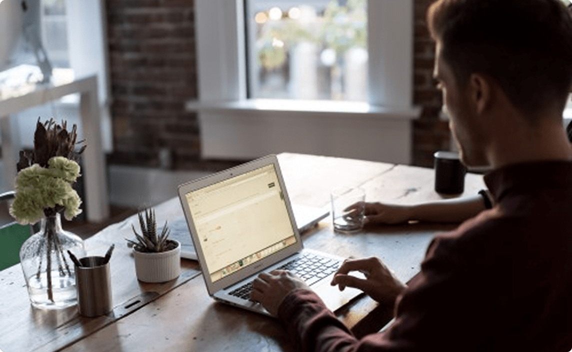 Someone working on a course online at home on a laptop.