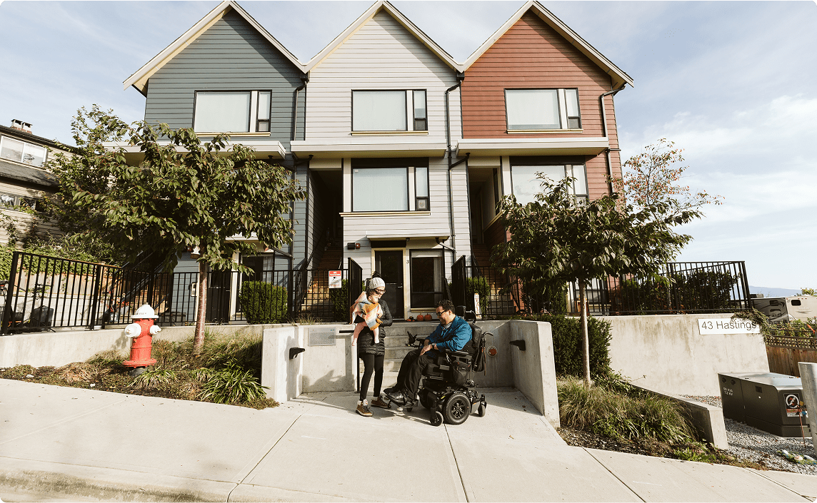 People in front of new housing.