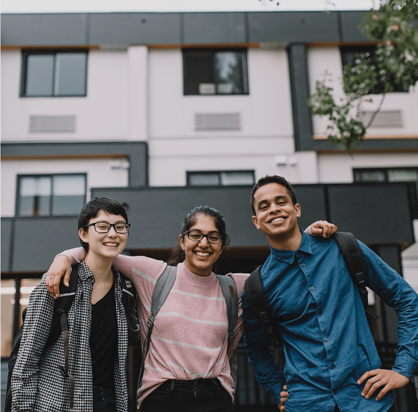 Three people smiling
