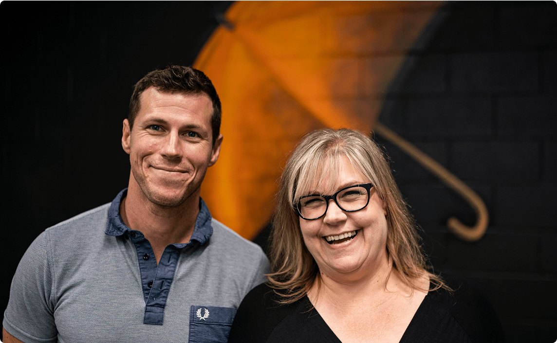 Two people smiling at the camera.