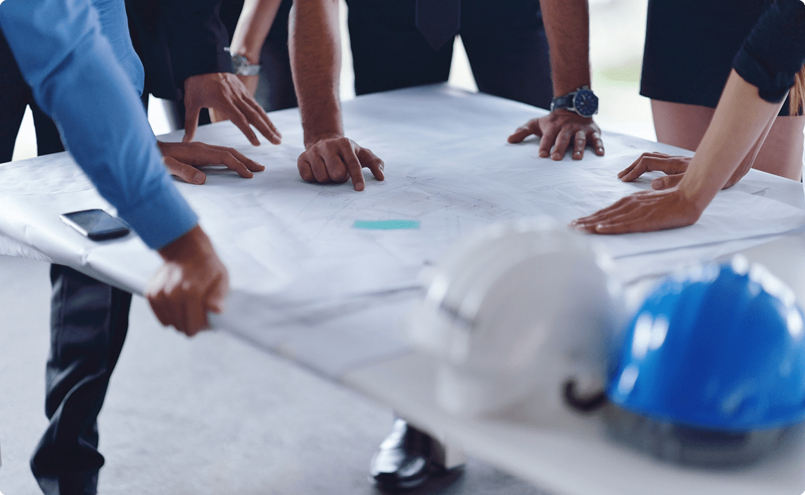 A group of engineers looking at blueprints.
