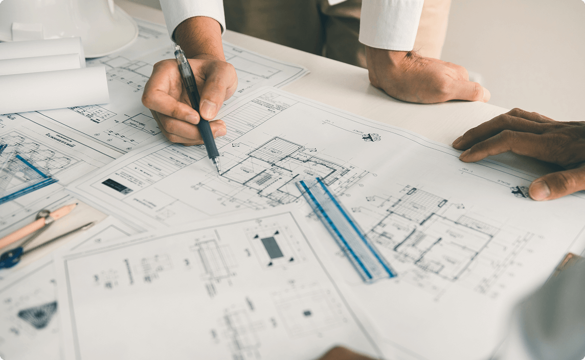 Reviewing blueprints with a pencil.