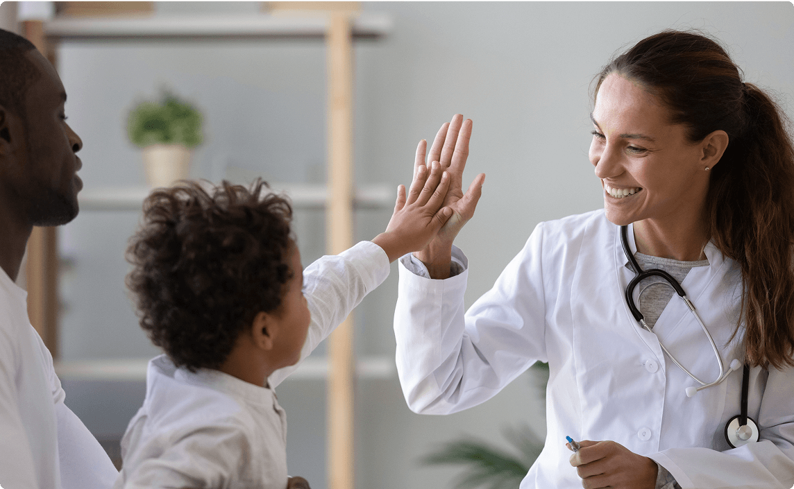 A doctor high fiving a patient.