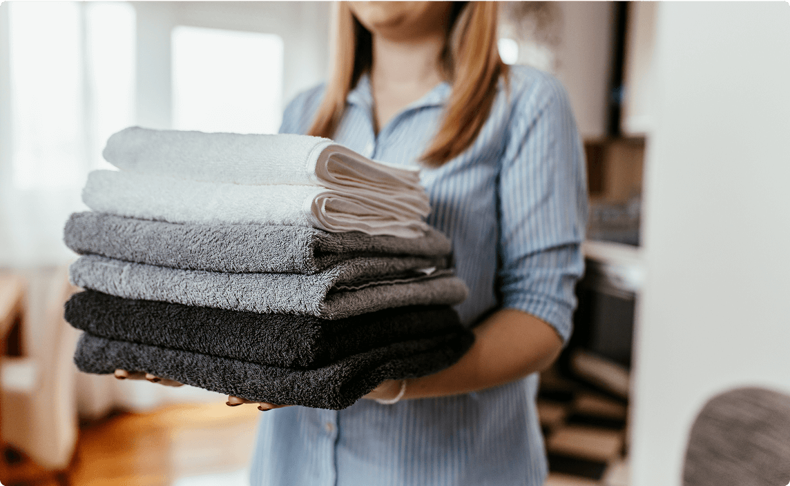 A woman carrying towels.