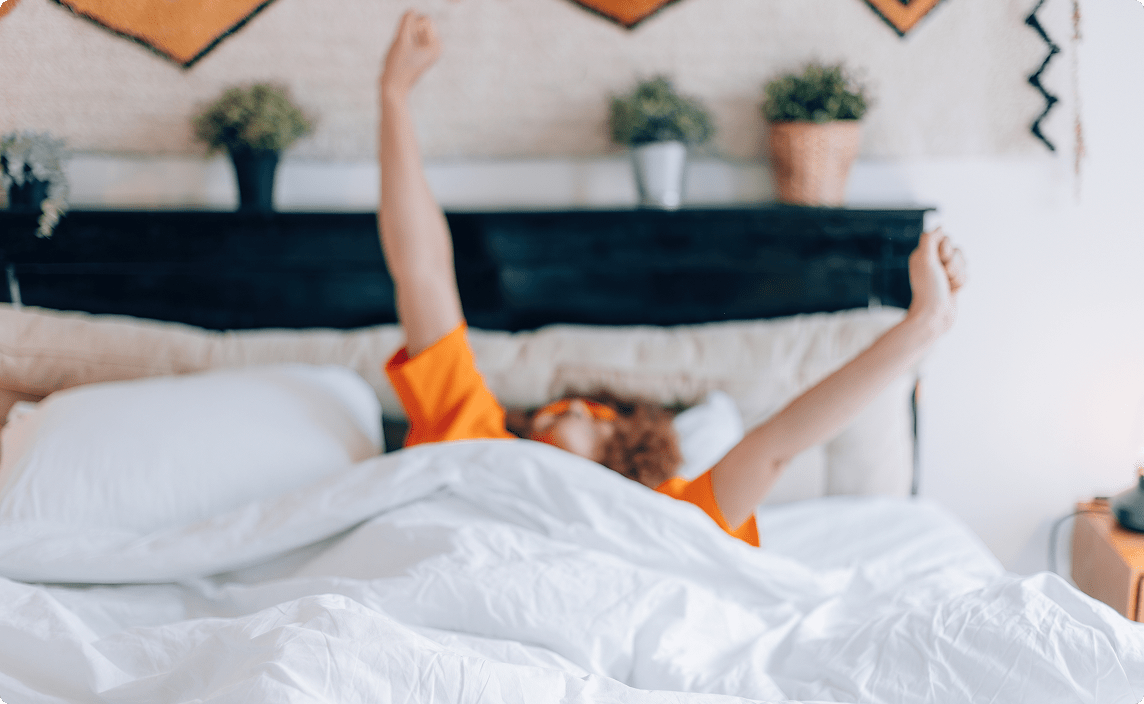 Someone waking up in bed.