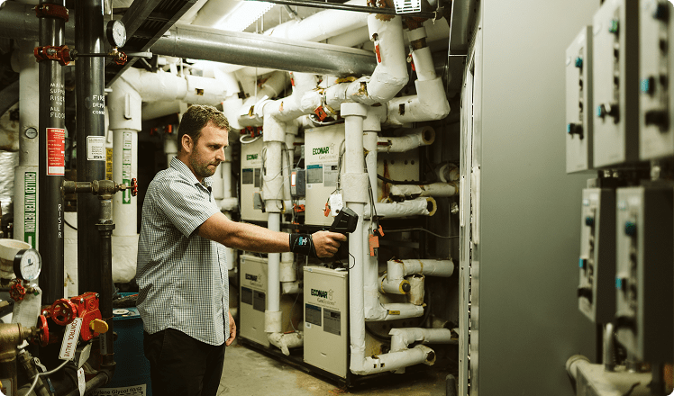 Looking at pipes in a basement.