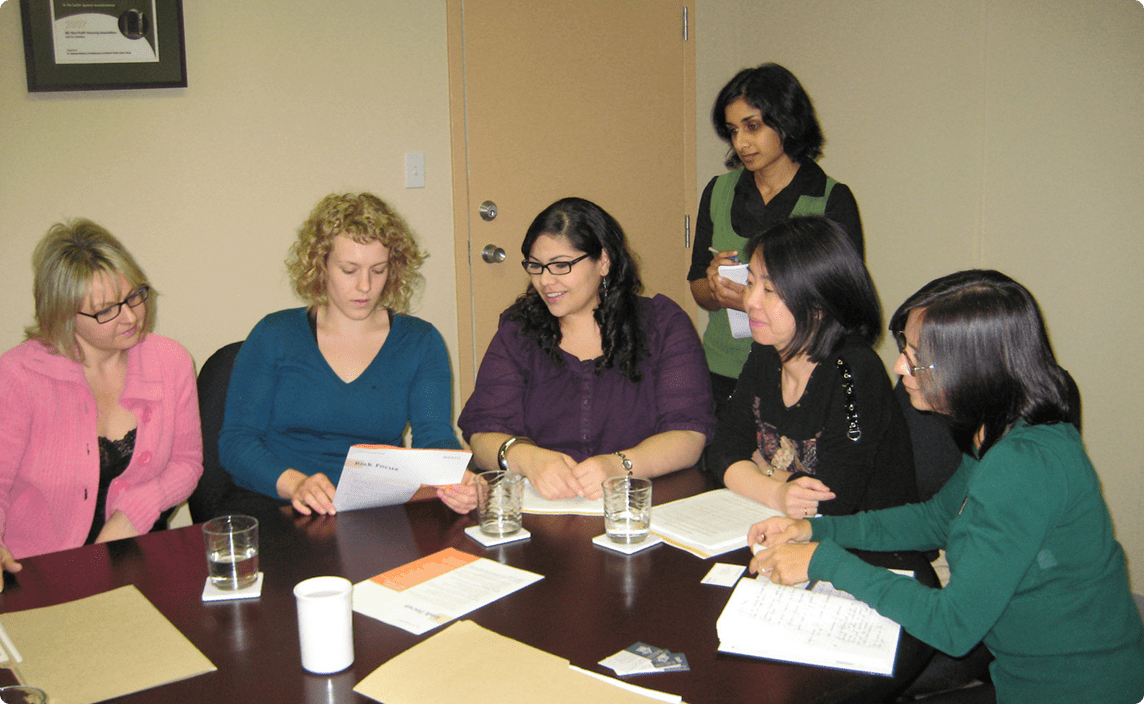 BCNPHA team members discussing documents collaboratively.