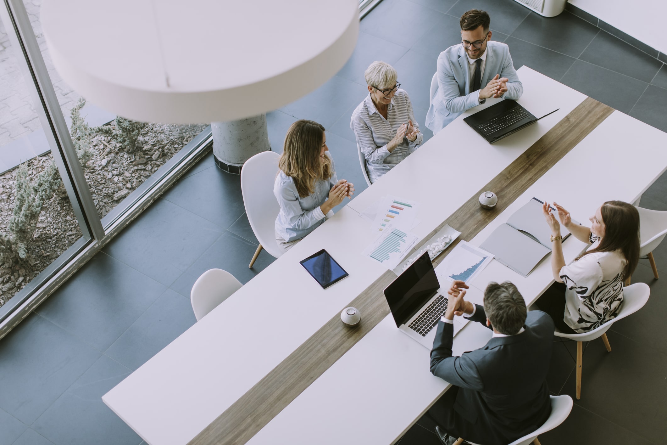Professionals meeting around a boardroom table at a meeting.